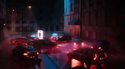 a group of cars driving down a street at night