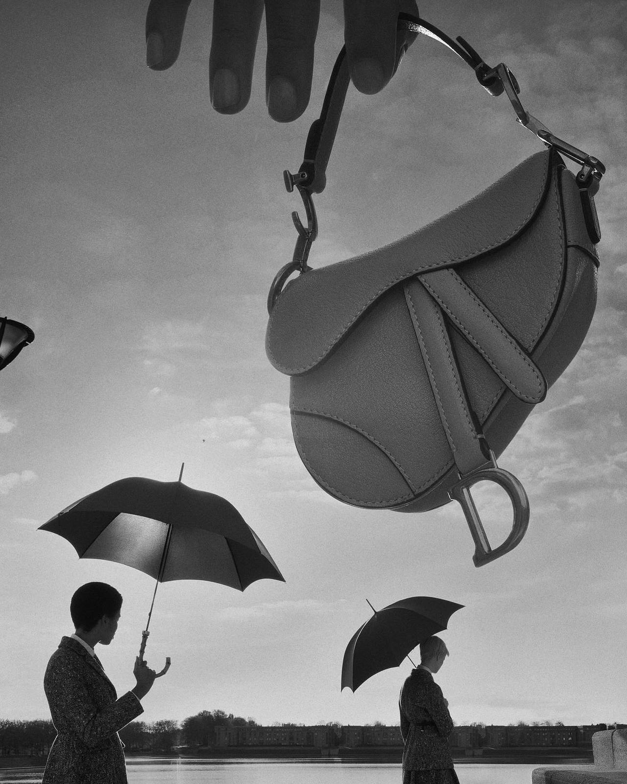 a couple of people standing next to each other holding umbrellas