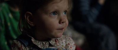 a close up of a child with blue eyes