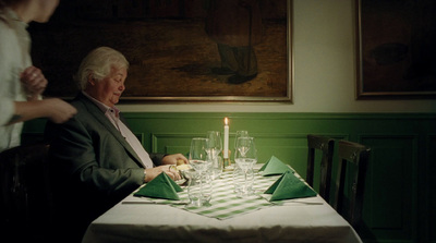 a man and a woman sitting at a table in a restaurant