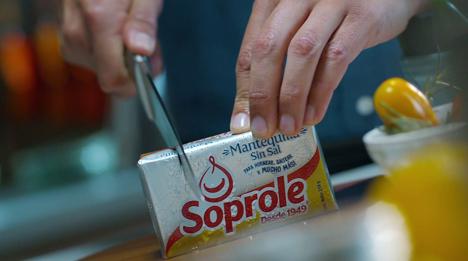 a person cutting a piece of food with a knife