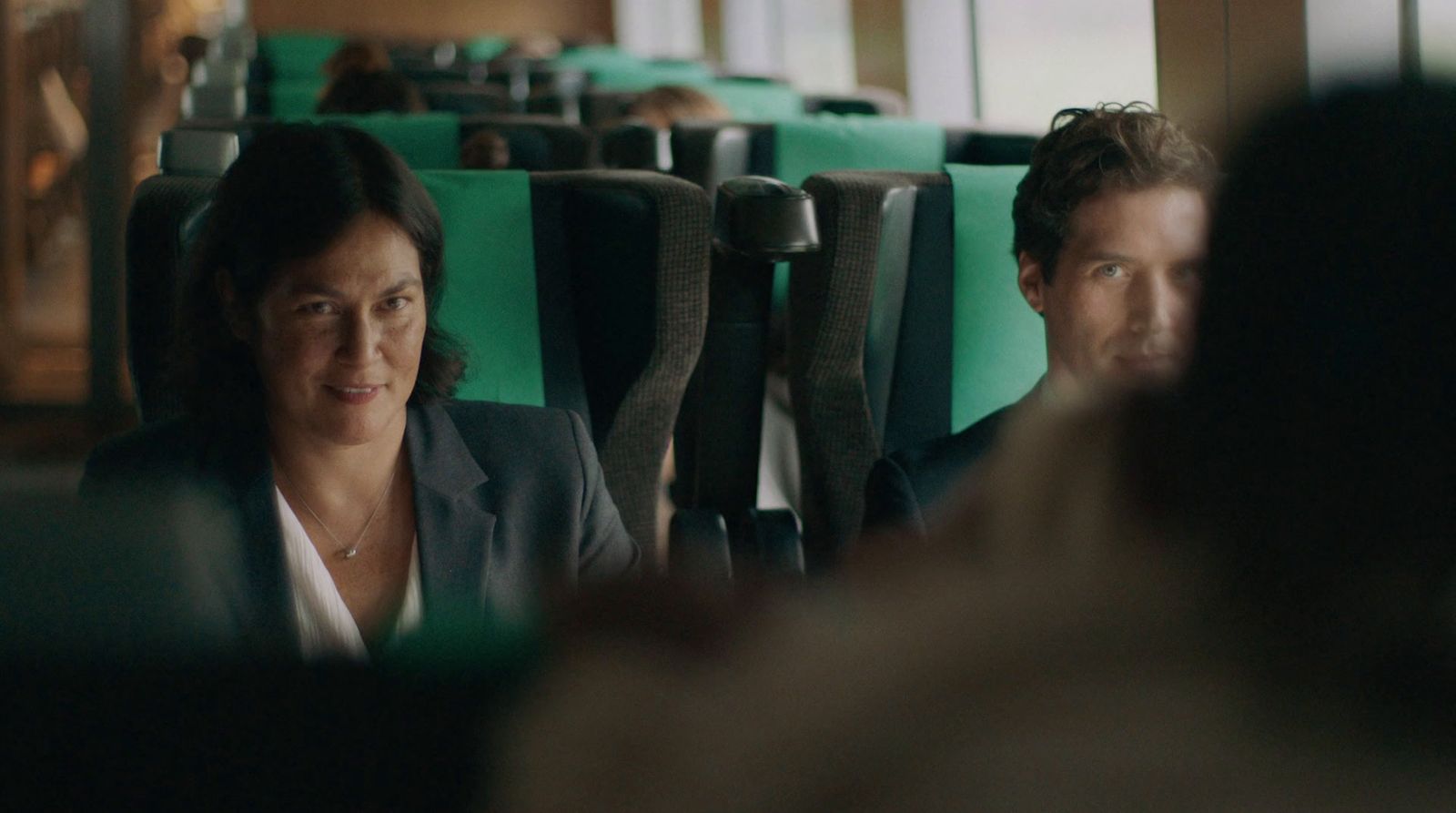 a woman sitting next to a man on a bus