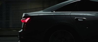 a close up of the tail lights of a black car