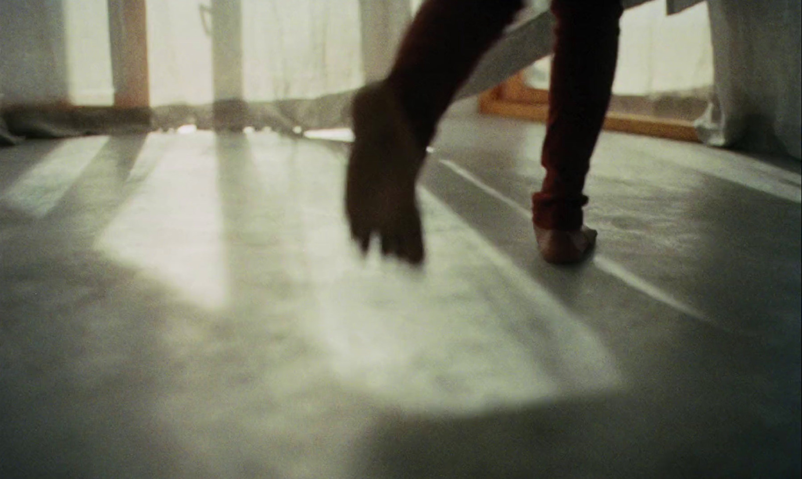 a person walking across a white floor in a room