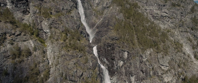 an aerial view of a waterfall on the side of a mountain