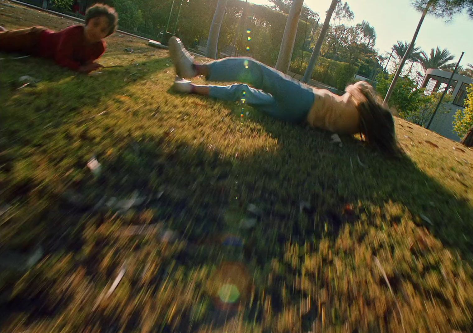 a woman laying on the ground next to a man