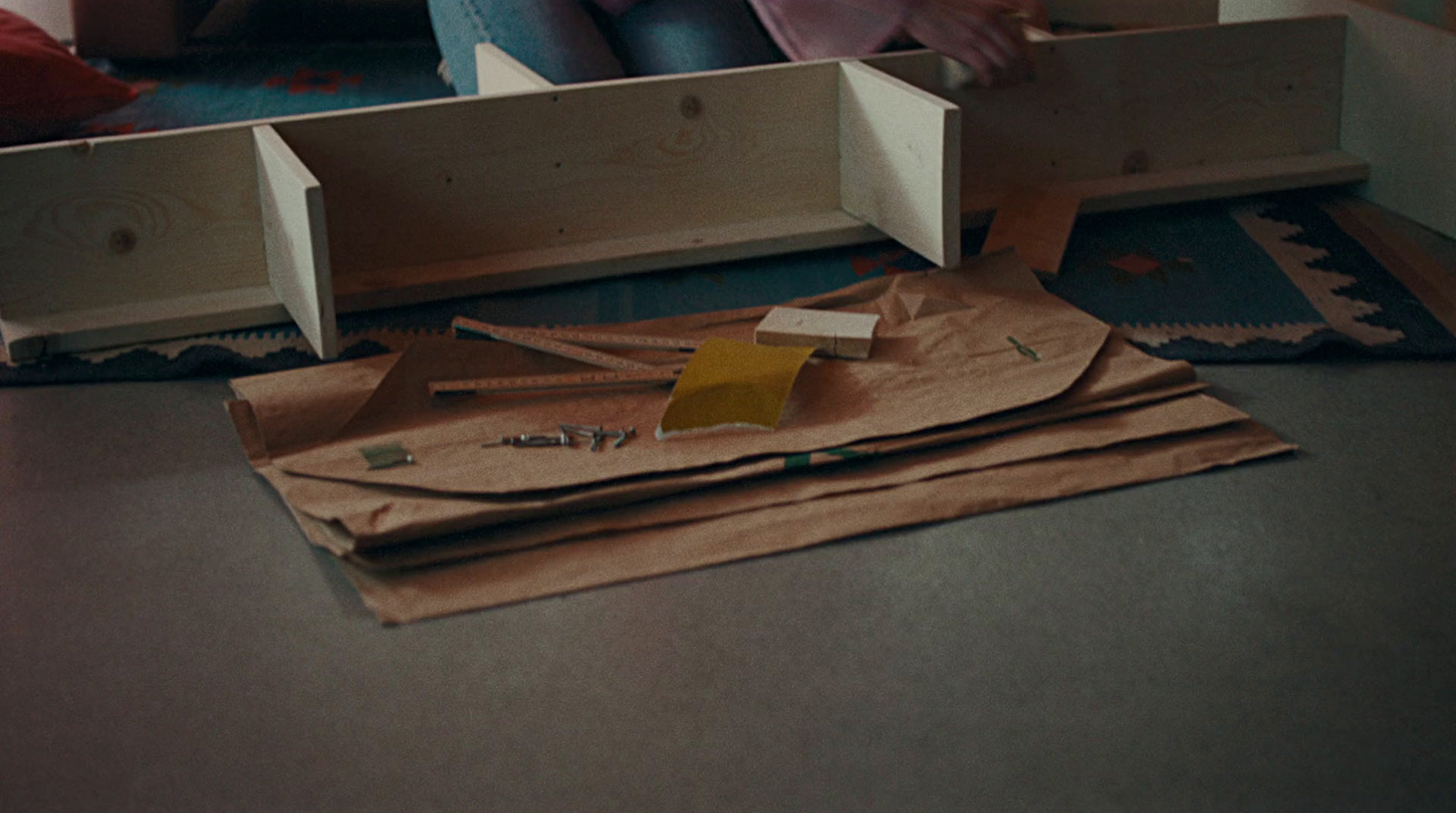 a woman sitting on the floor working on a project