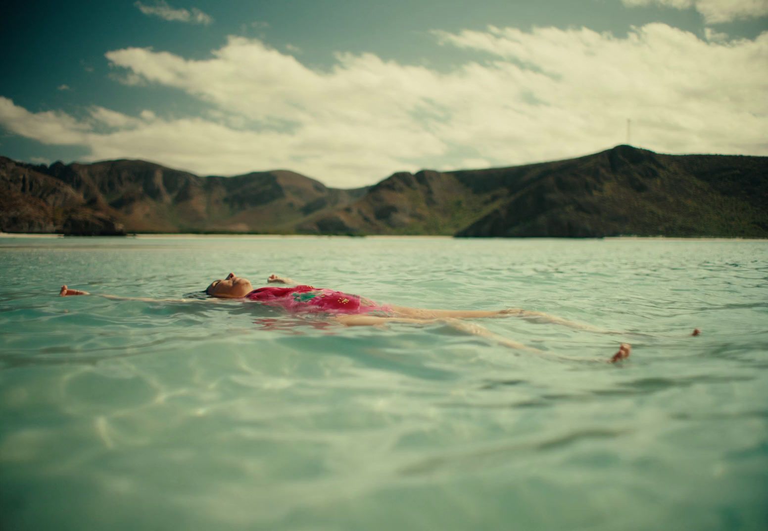 a person floating in the water with a life jacket on