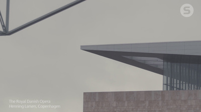 an airplane flying over a building with a sky background