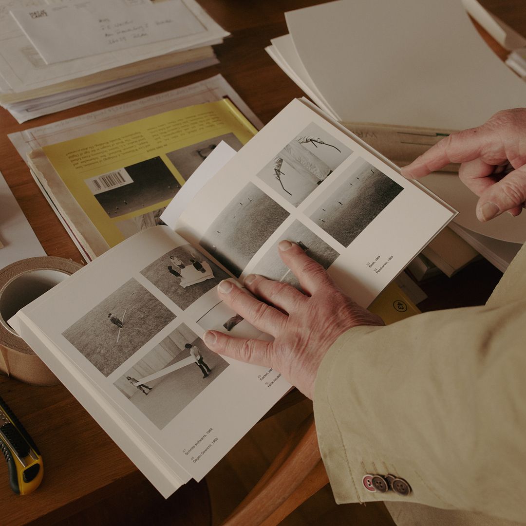 a person is holding a book open on a table