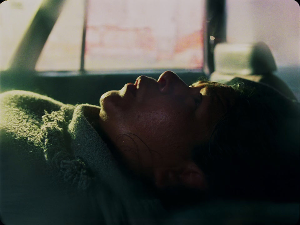 a woman laying in a car with her eyes closed