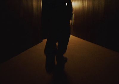 a person standing in a dark room with a light on