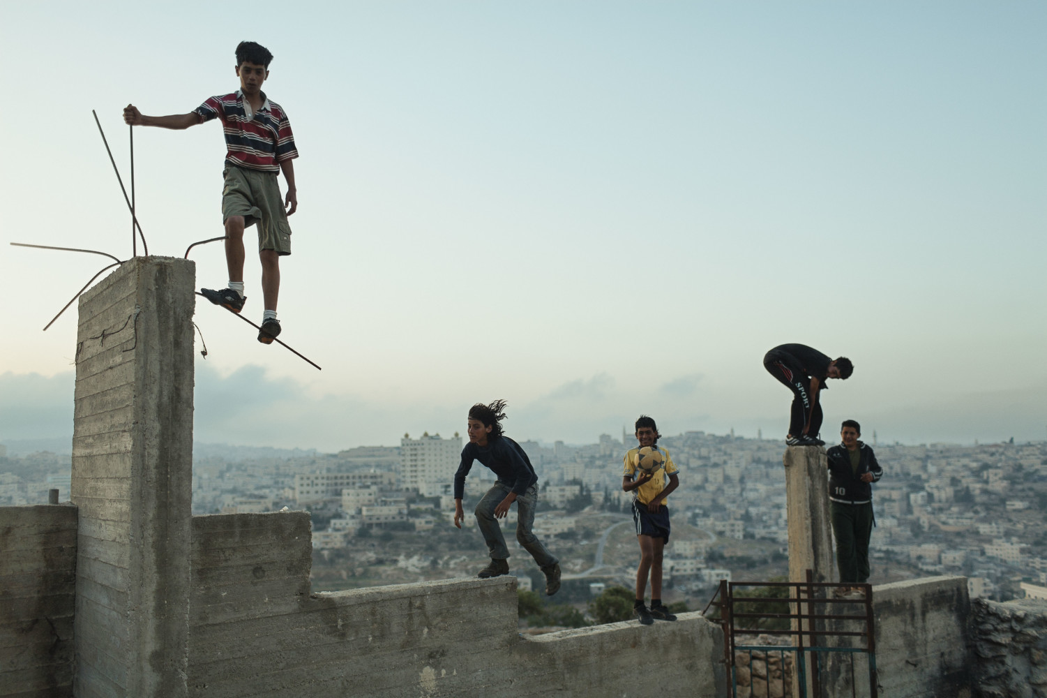 a group of people standing on top of a cement structure