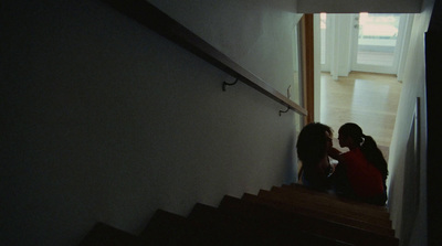 a couple of women standing on top of a set of stairs