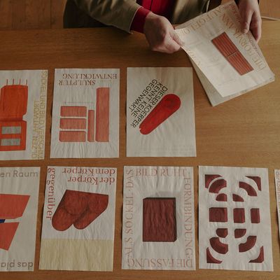 a person sitting at a table with several pieces of paper