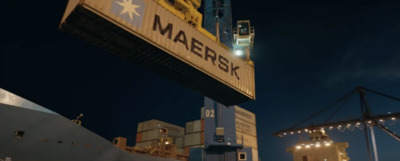 a crane is lifting a container onto a ship