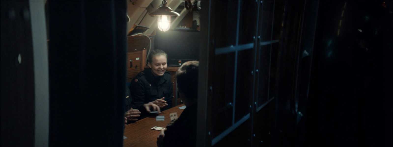 a man sitting at a table in a dark room