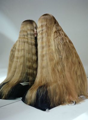 a couple of long blonde hair sitting next to each other