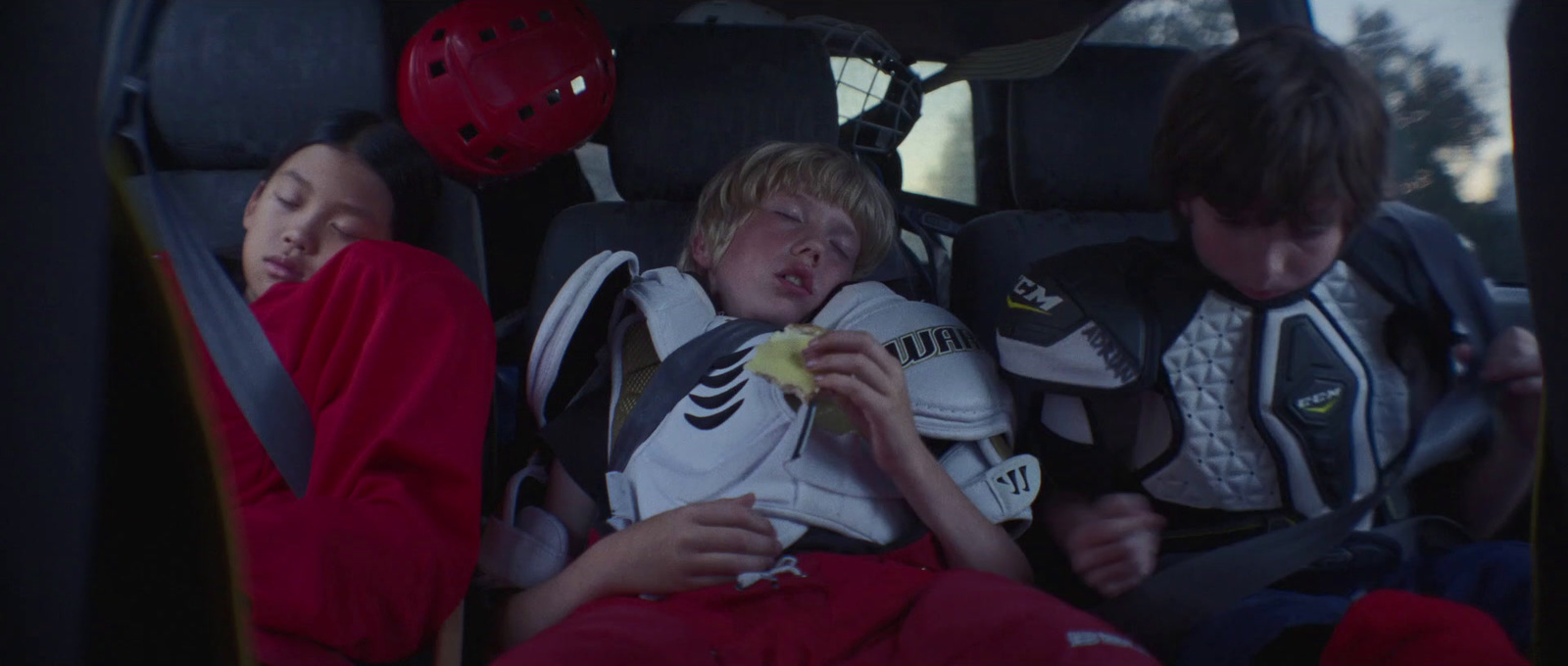 two children sleeping in the back of a car