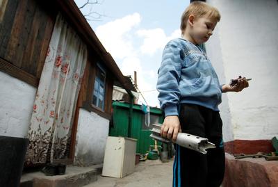 a young boy holding an object in his hand