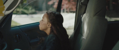 a woman sitting in the passenger seat of a car