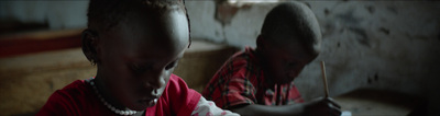 two young boys in red shirts are looking at something