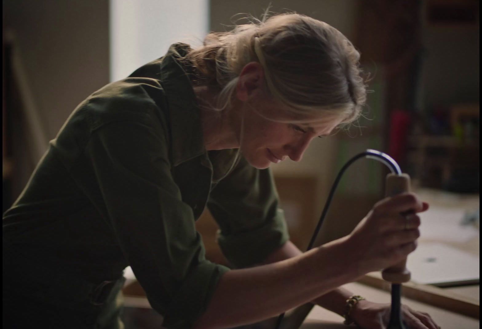 a woman holding a stethoscope in her right hand