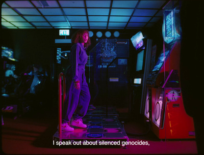 a woman standing in front of a video game machine