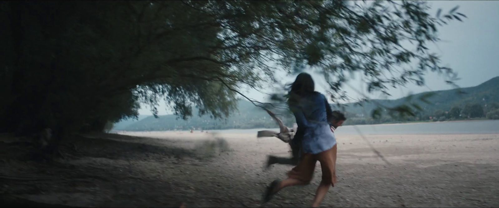 a woman holding a baseball bat on top of a field