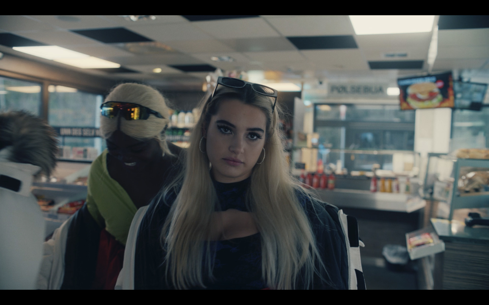 a woman with long blonde hair standing in a store