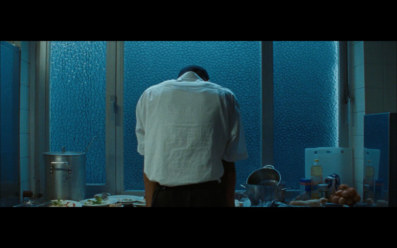 a man standing in front of a sink in a bathroom