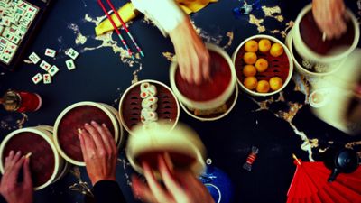 a group of people holding cups with food in them