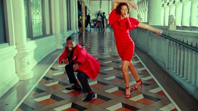 a woman in a red dress and a man in a black suit