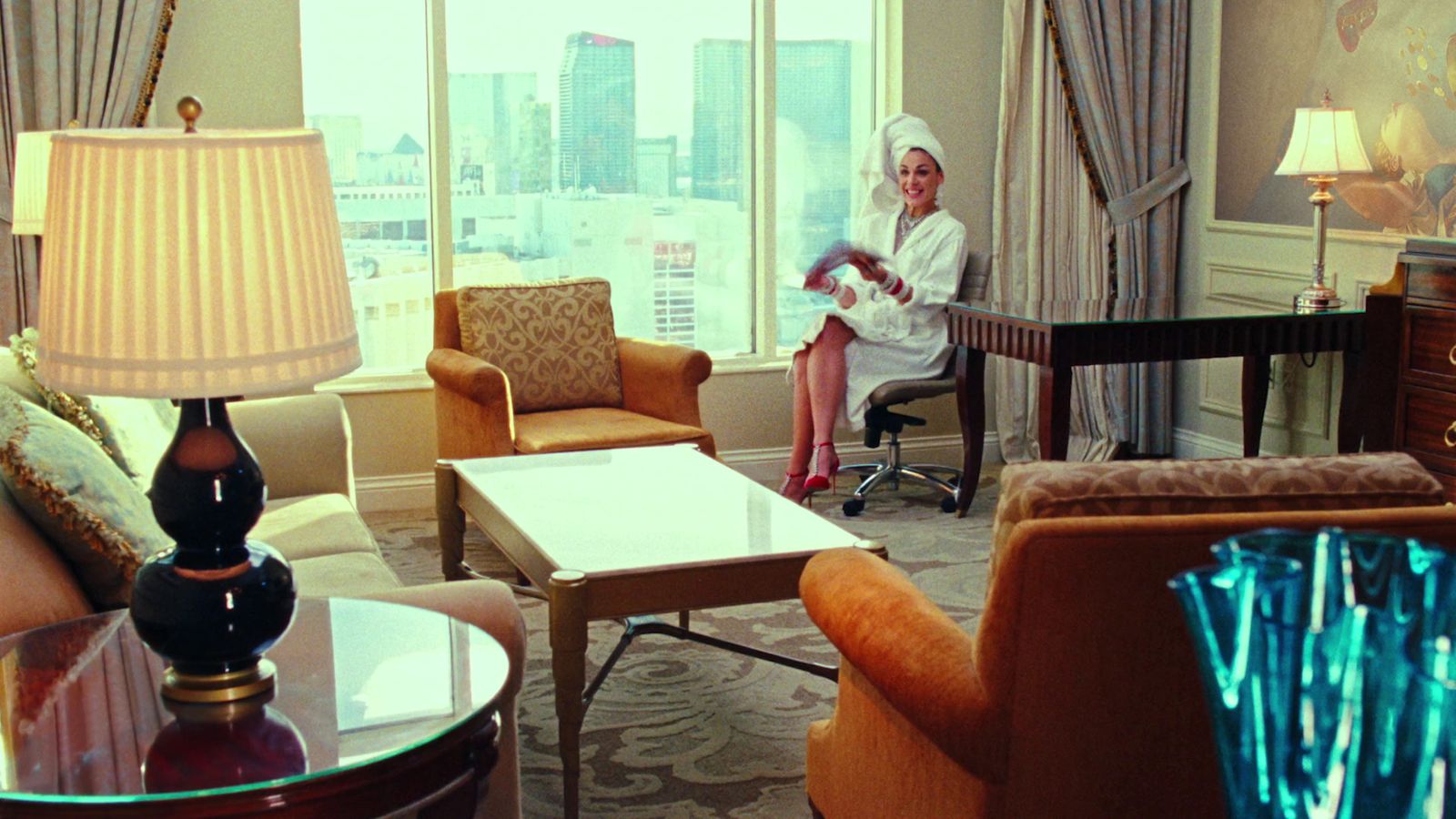 a woman sitting in a living room next to a window