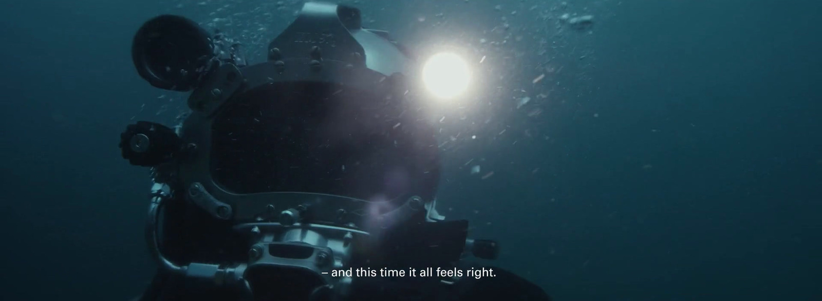 a scuba diver with a flashlight in the water