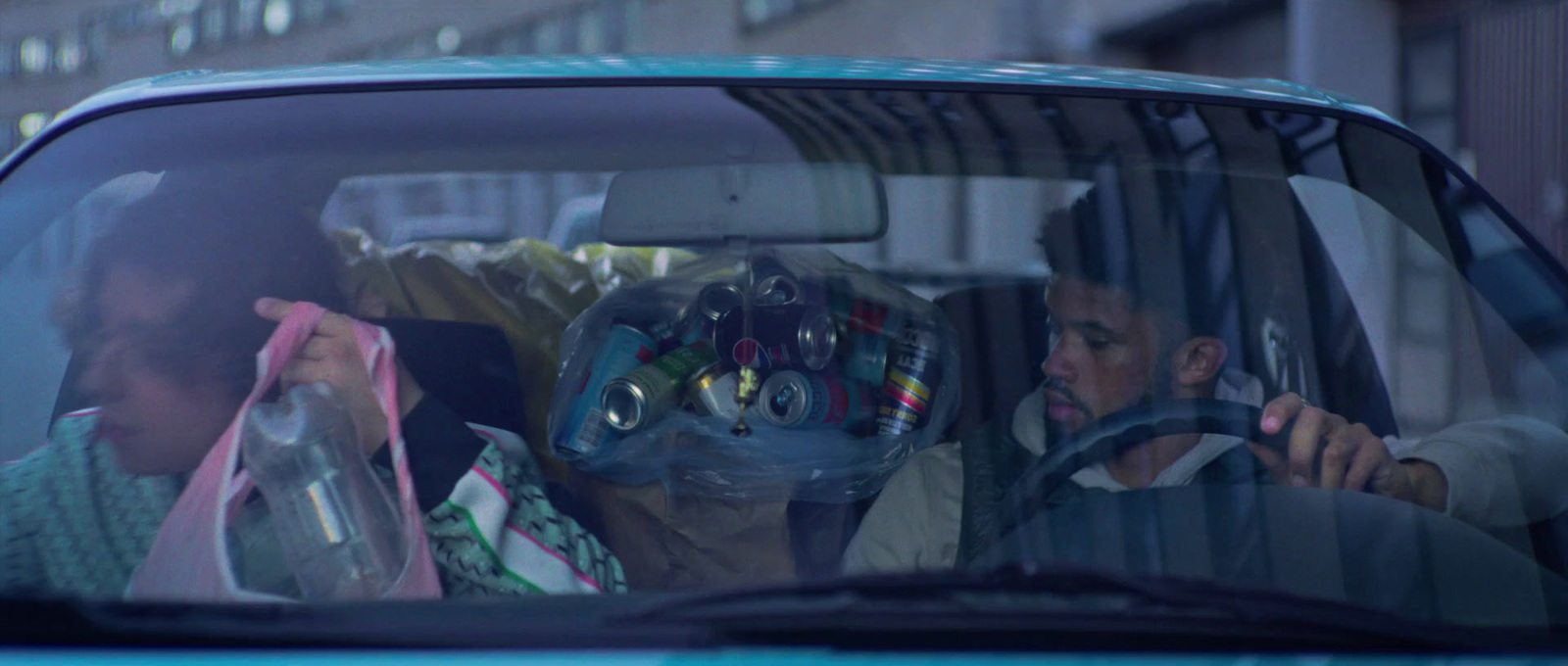 a man and a woman sitting in a car
