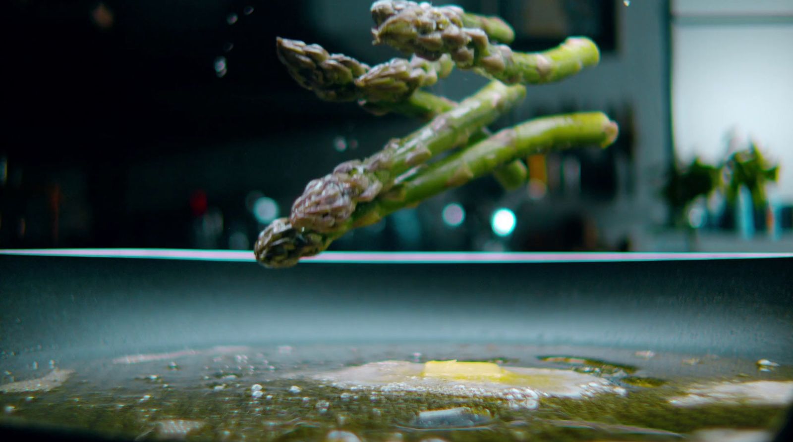 asparagus being cooked in a frying pan