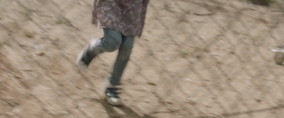 a blurry photo of a person walking on a dirt path