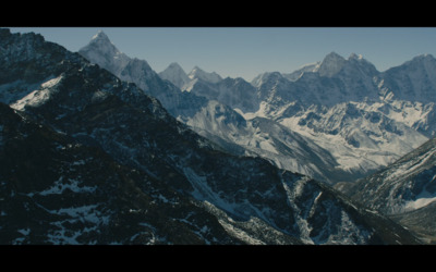 a mountain range with snow covered mountains in the background