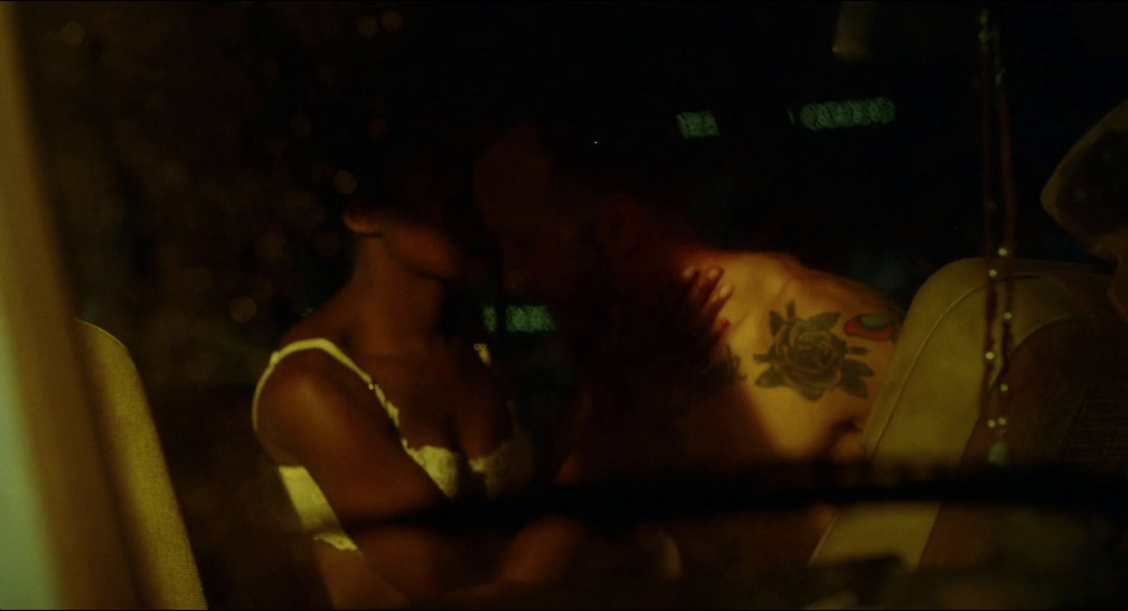 a man and a woman kissing in a car