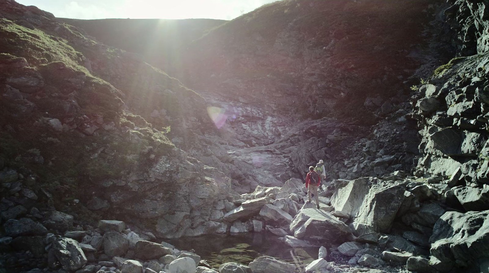 a person walking up a rocky mountain side