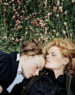 a couple of women laying next to each other