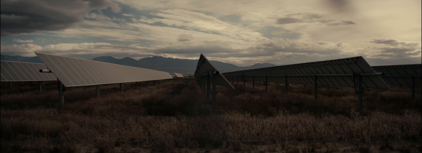 a group of metal structures sitting in a field