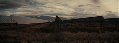 a group of metal structures sitting in a field