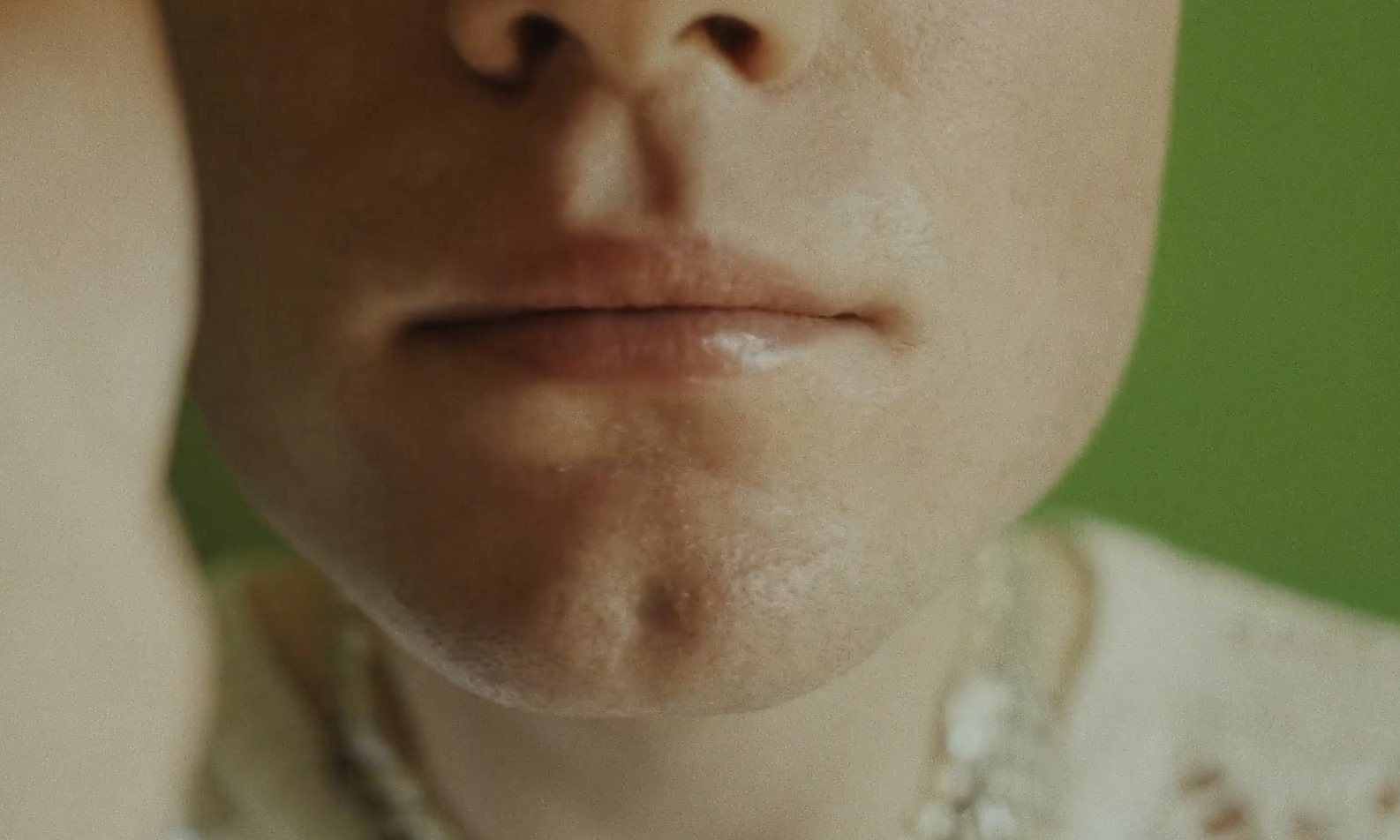 a close up of a person wearing a necklace