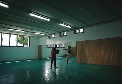 a couple of people in a room with a ball