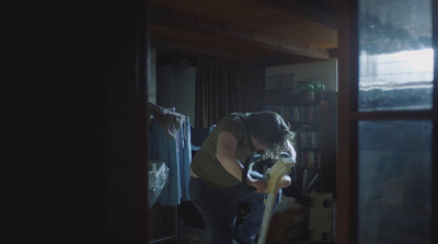 a woman standing in a room holding a skateboard