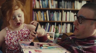 a man and a little girl sitting at a table