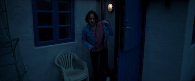 a woman standing in a doorway of a house