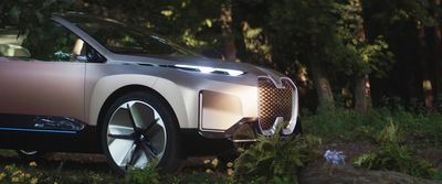 an electric car parked in the woods at night